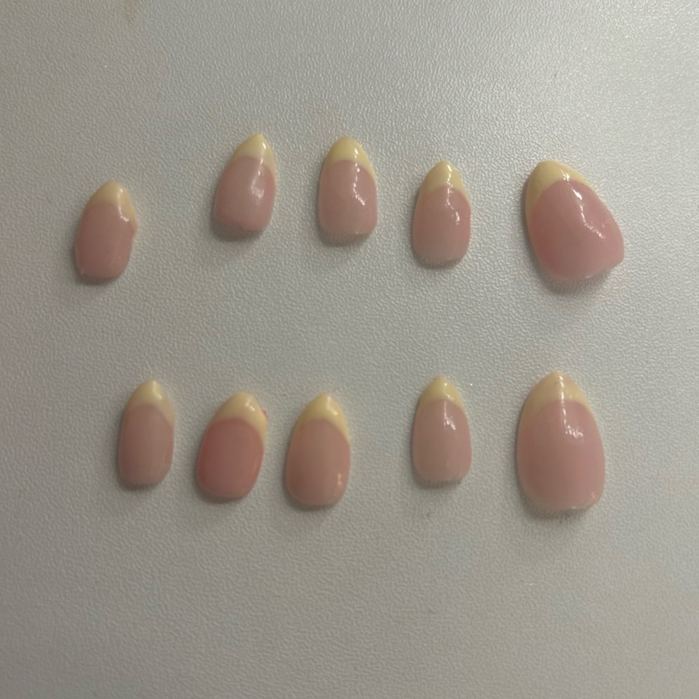 Yellow french tip nails.